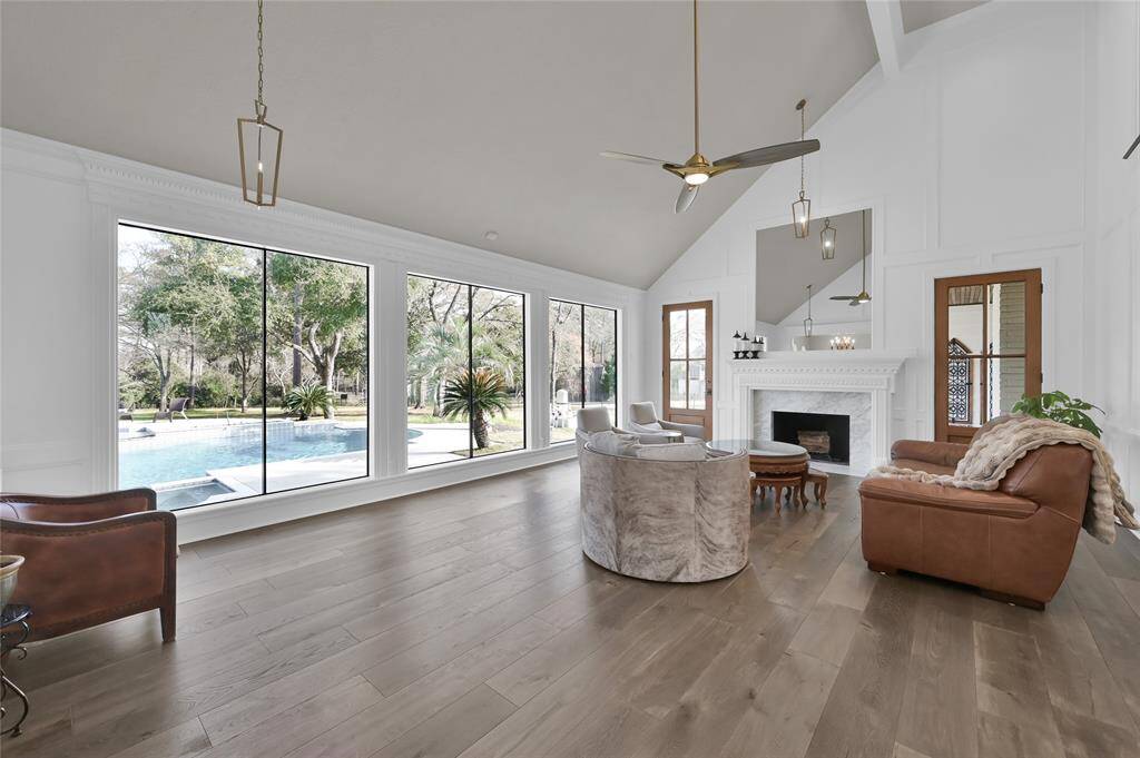 This living room is huge and features floor to ceiling windows, soaring ceilings, and stunning views. The wood burning fireplace really brings home the ambiance of this place to gather room.