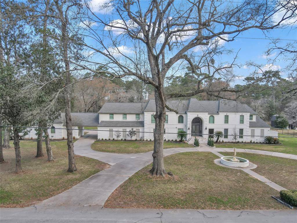 Owners entrance to the left accesses the huge 3 car garage and additional parking while the circle drive welcomes your visitors.
