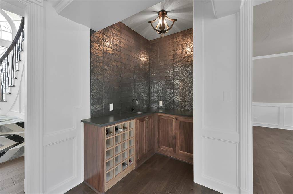 The wet bar area is perfectly situated close to all the entertainment and boasts tons of storage.