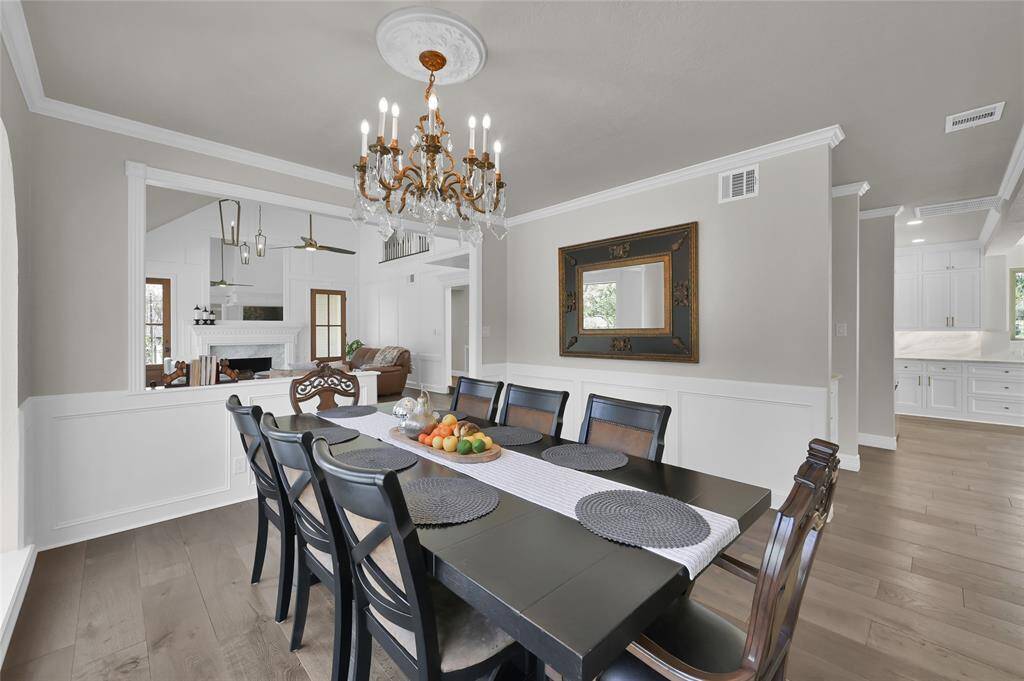 Another view of the formal dining room with a glimpse into the immaculate kitchen.