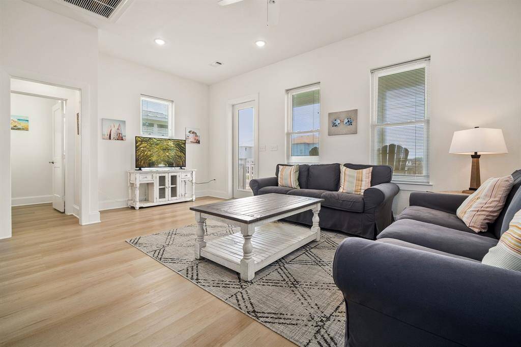 Another view of the living room area and half bath entrance. Coastal charm at its best!