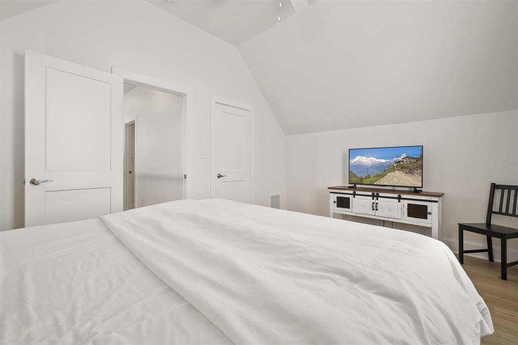 From another angle, the secondary bedroom reveals even more of its coastal charm and thoughtful design.