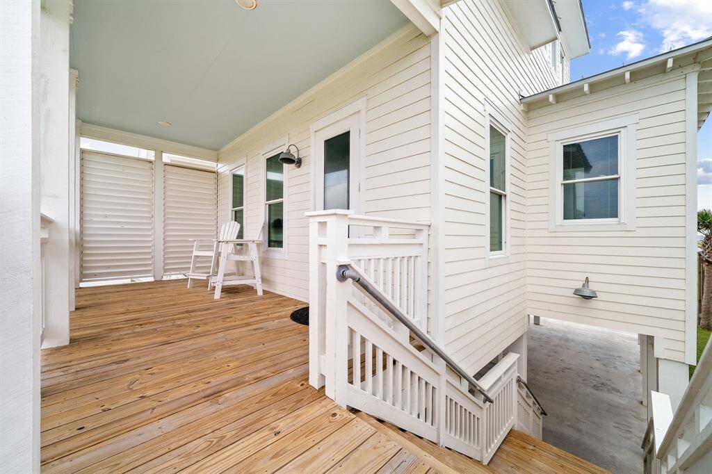From this elevated vantage point, you can view the covered parking breezeway, a sanctuary of shade and convenience nestled beneath the architectural charm of the home.