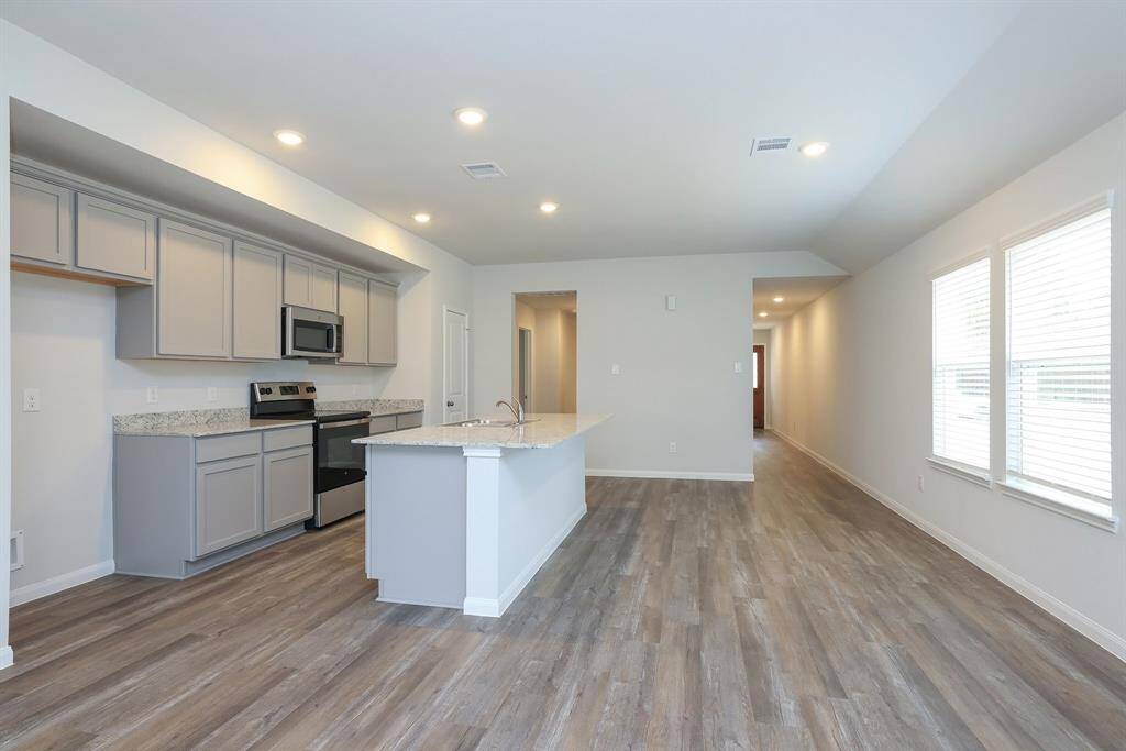 Canned lighting assists with meal prep keeping the Kitchen and Dining area light and bright.