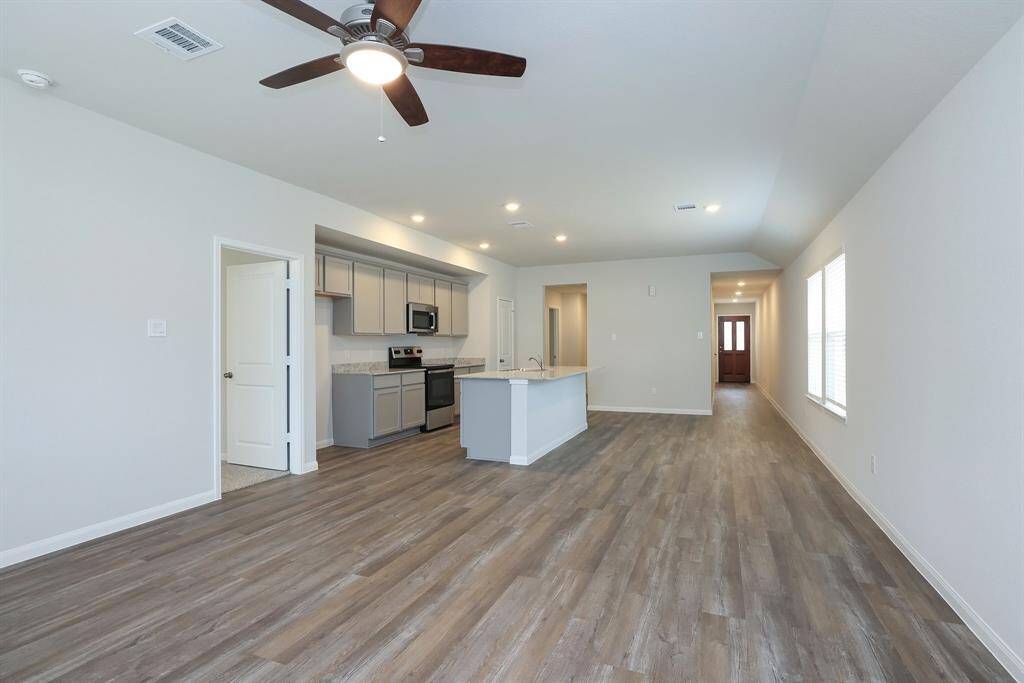 This view shows the sightlines to the front Entry and the hallway leading to the secondary bedrooms.
