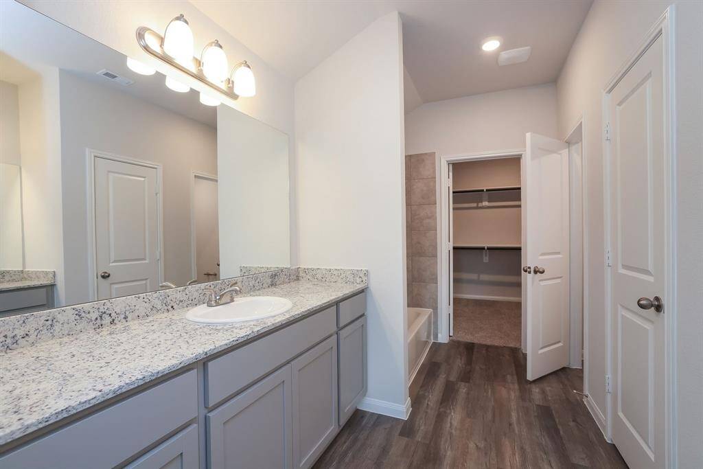 The expanded granite counter top can hold lotions and potions while the spacious cabinetry below has room for towels and other necessities.