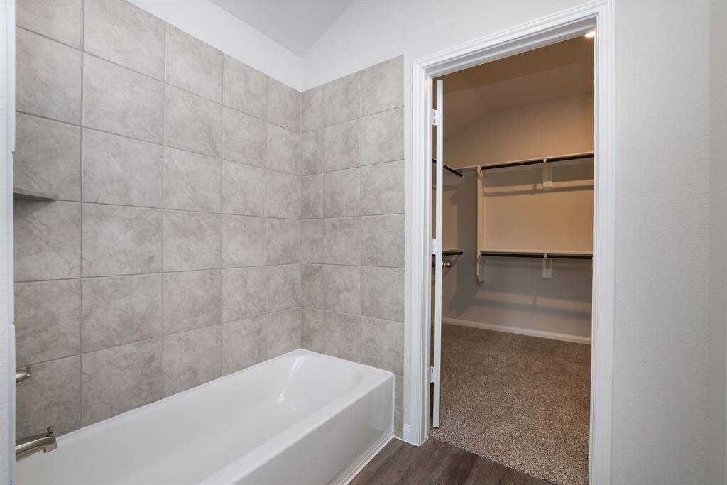 Soak away the day in the tiled shower/tub combination. All you need is a book, bubbles, and a bevy!