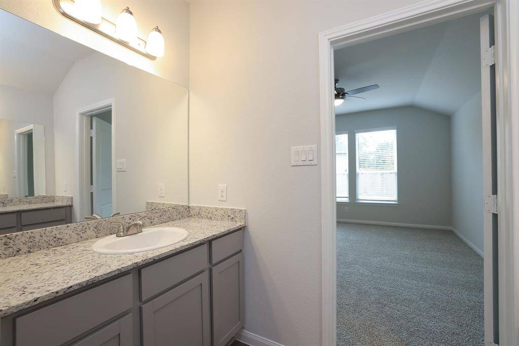The second vanity has plenty of storage and is highlighted by the overhead light fixture.