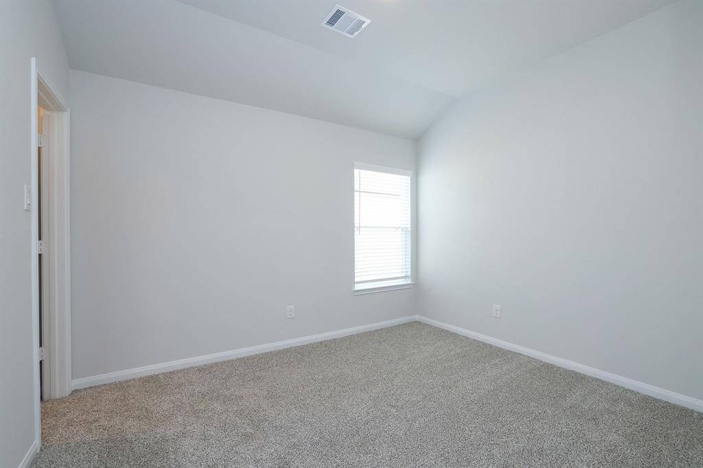 Bedroom #3 features carpet in a neutral tone and ceiling light. Ideal for a bedroom or office space.