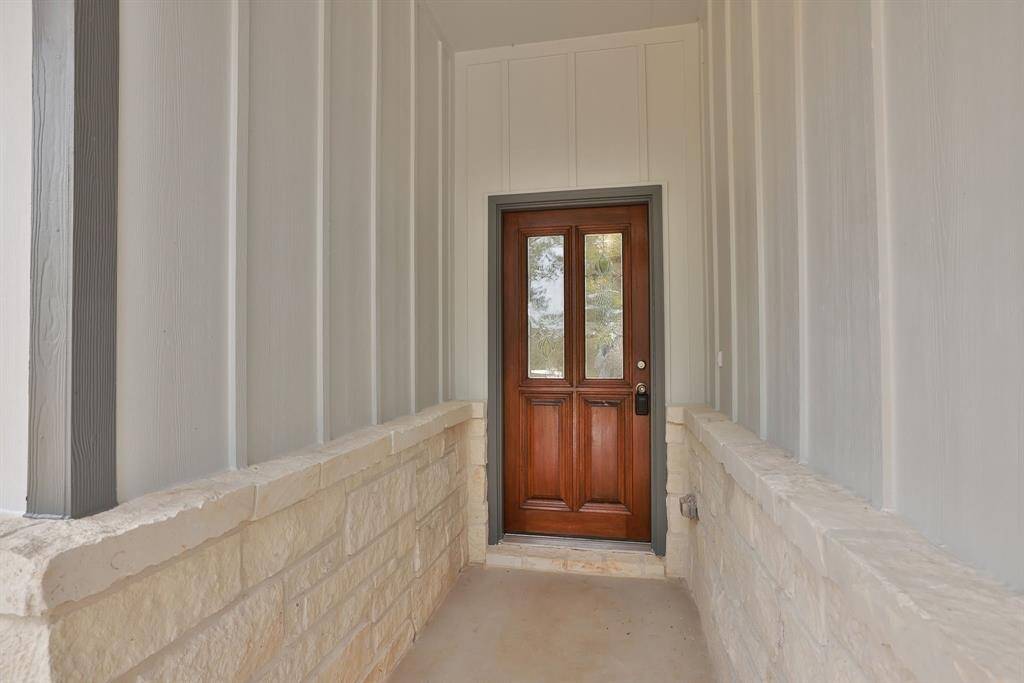 A stunning wood door with glass panels greets your family and friends, while the covered front porch will keep your deliveries nice and dry.