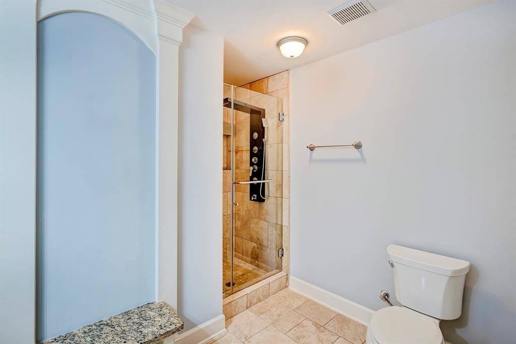 Primary bedroom wihout furniture. One door leads  to ensuite bath