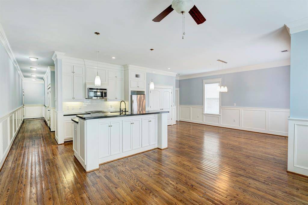 Large island kitchen is open to the living and dining areas. The space can be however you want to use it.