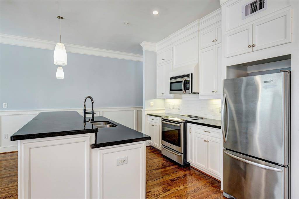 The owner used the space by the door to the balcony area and the 3 pinnacle lights as a dining area. The  area in under the ceiling fan as the den/living area