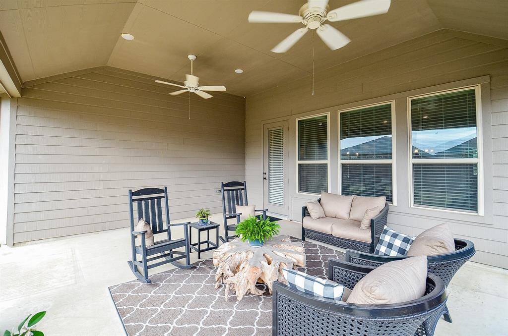 Two ceiling fans provide a refreshing breeze on warm summer days, ensuring comfort while you relax or host outdoor gatherings.