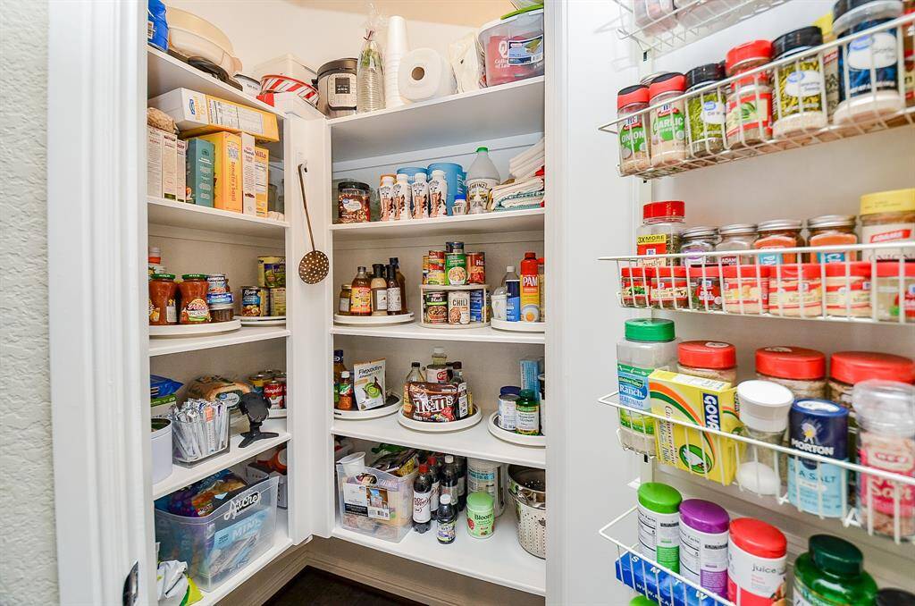 A walk-in pantry ensures that every ingredient and kitchen gadget has its place, offering generous shelving to keep everything organized and within reach.