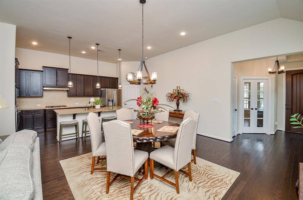 The dining area serves as a perfect link between the kitchen and family room, creating a cohesive flow for daily living and entertaining.