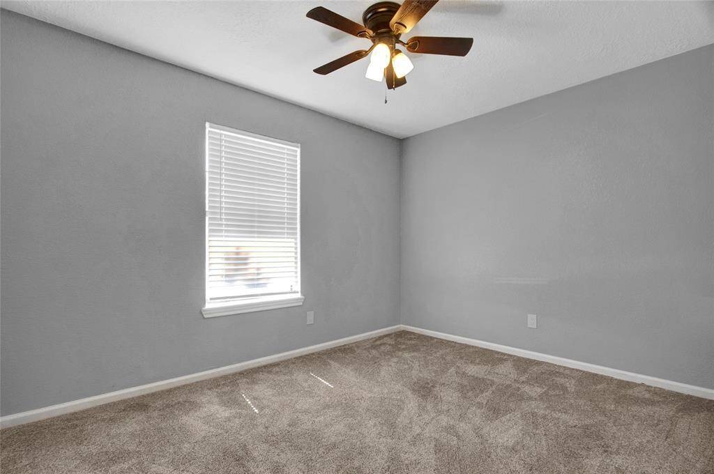 The third bedroom is also towards the front of the house with neutral colors.