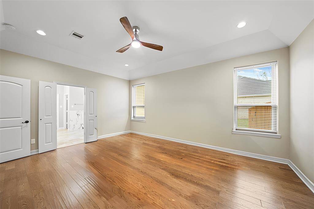 The primary suite is beautifully flanked by a private sitting area, offering direct access to the covered patio and spa-like ensuite bath and walk-in closet completing the retreat.