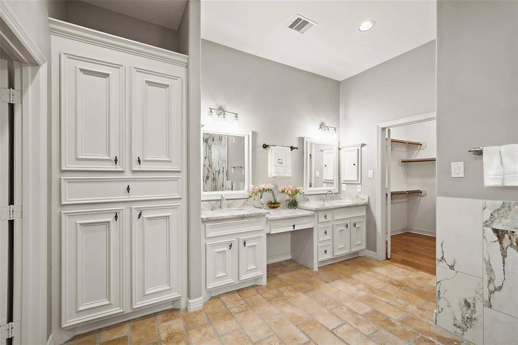This inviting sitting area features a charming bay window and a cozy fireplace, creating the perfect space to relax. With direct access to the covered back patio, it offers seamless indoor-outdoor living.