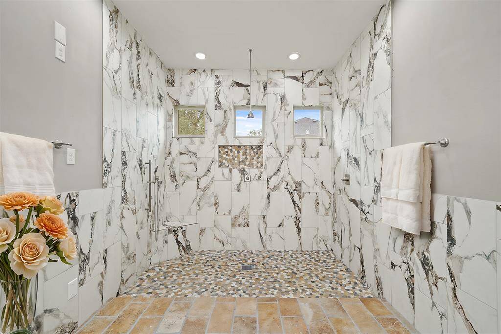 The primary ensuite  featuring a spacious walk-in shower, dual sinks, private water closet and a generously sized walk-in closet complete this luxurious bathroom retreat.
