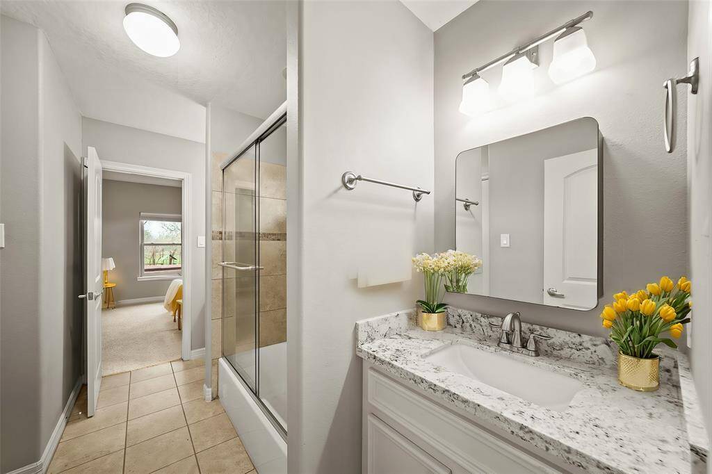 One of two generously sized secondary bedrooms serviced by an ensuite Jack and Jill ensuite bathroom, providing comfort and privacy.