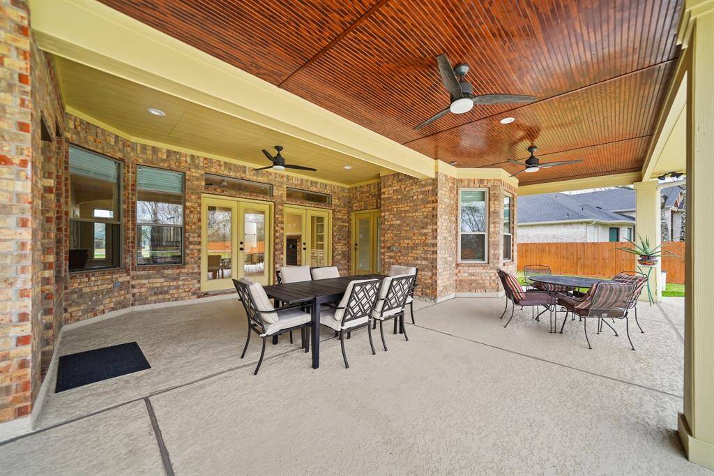 The well-sized covered patio provides convenient access from the breakfast room and primary bedroom sitting area, seamlessly blending indoor and outdoor living. Overlooking the pool and play area in the generously sized backyard, it’s an ideal space for relaxation and entertaining.