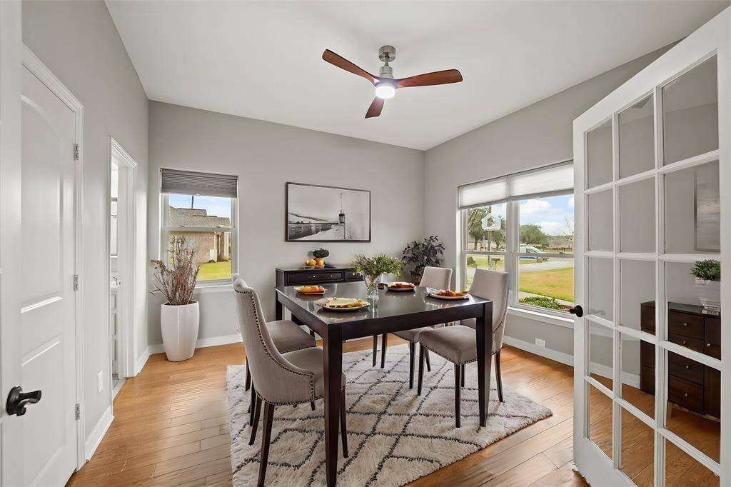 Step into a grand wood-floor entryway, flanked by formal living areas on both sides. Above, the upstairs landing overlooks the space, adding a touch of architectural sophistication and openness.