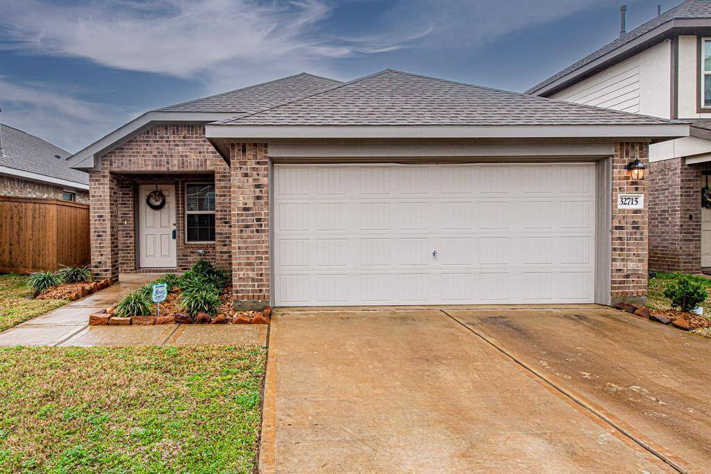 Charming three-bedroom, two-bath, single-story brick home with a two-car garage. The front yard is neatly landscaped with a welcoming front porch.