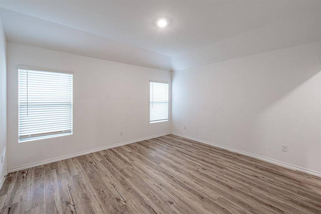 The main bedroom has an extensive closet, plenty of natural light, no carpet, pre-wired for a ceiling fan, and a private bathroom.