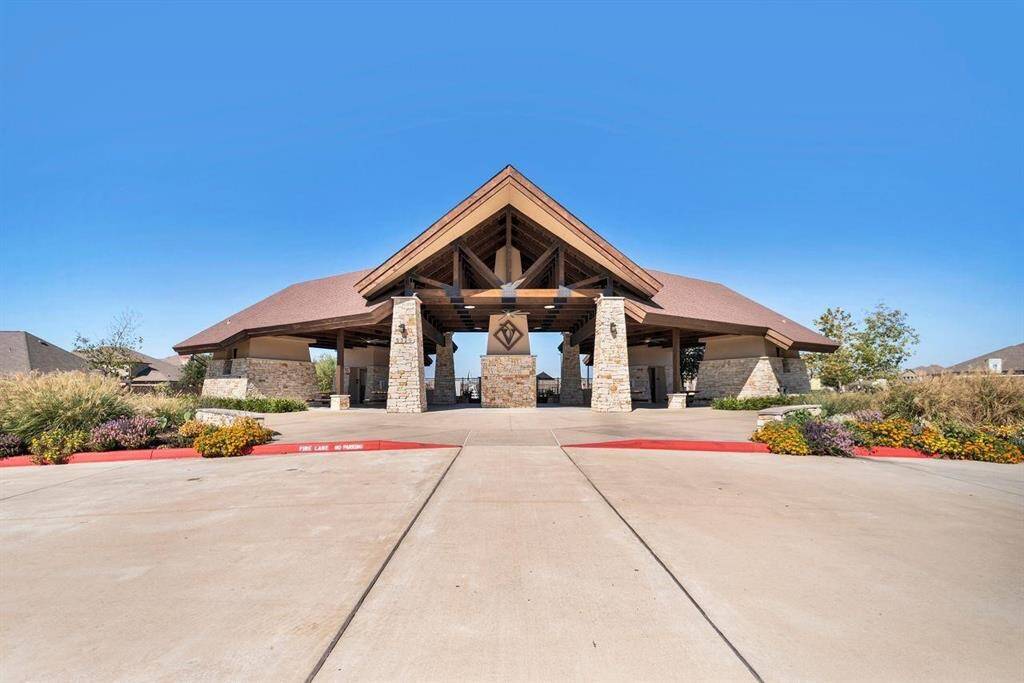 Elegant community pavilion with a welcoming entrance, stone pillars, and a pitched roof.