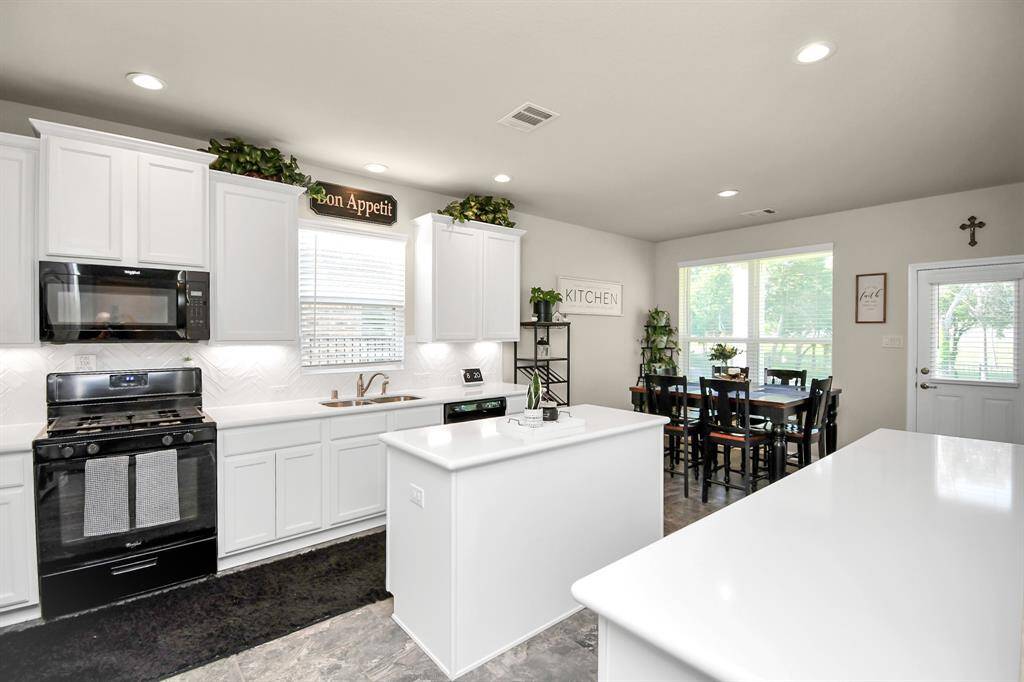 This home's open floor and beautiful kitchen really make this home shine with all of its amazing features. You have the beautiful white upgraded cabinets that give you plenty of storage. It has an island as well as a breakfast bar with plenty of room that is perfect to use as a buffet and an easy space and it all features a beautiful Quartz countertop.