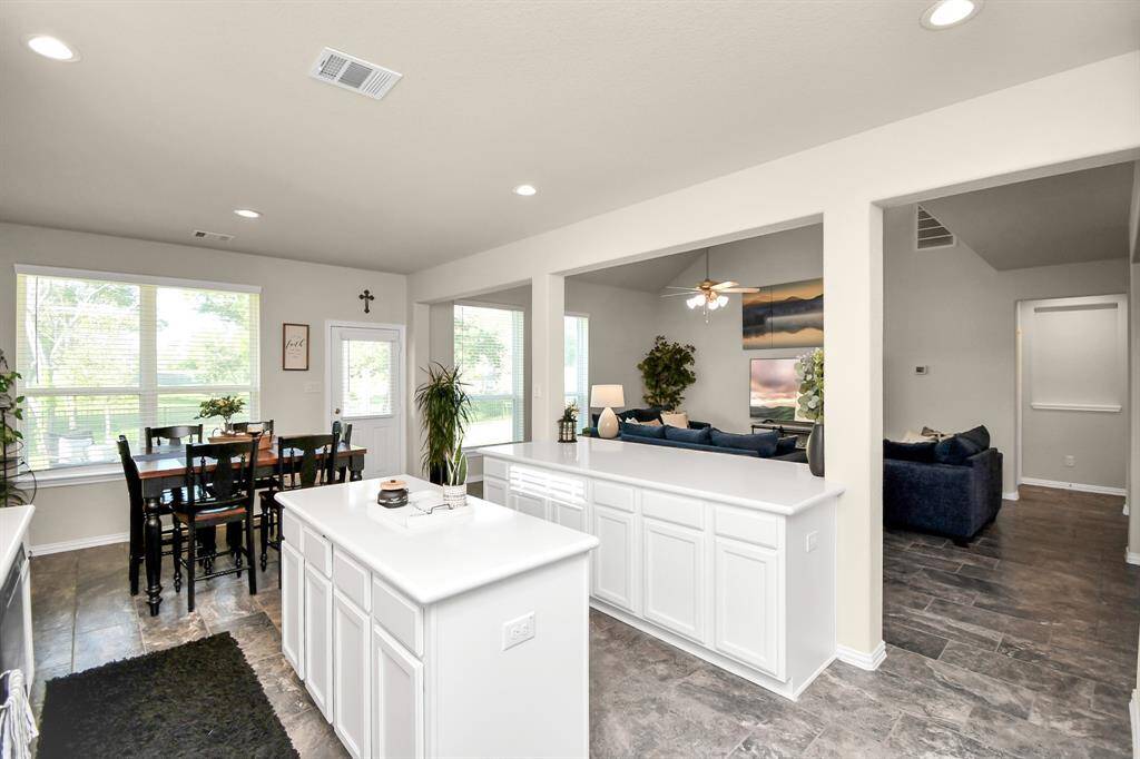 This home's open floor and beautiful kitchen really make this home shine with all of its amazing features. You have the beautiful white upgraded cabinets that give you plenty of storage. It has an island as well as a breakfast bar with plenty of room that is perfect to use as a buffet and an easy space and it all features a beautiful Quartz countertop.