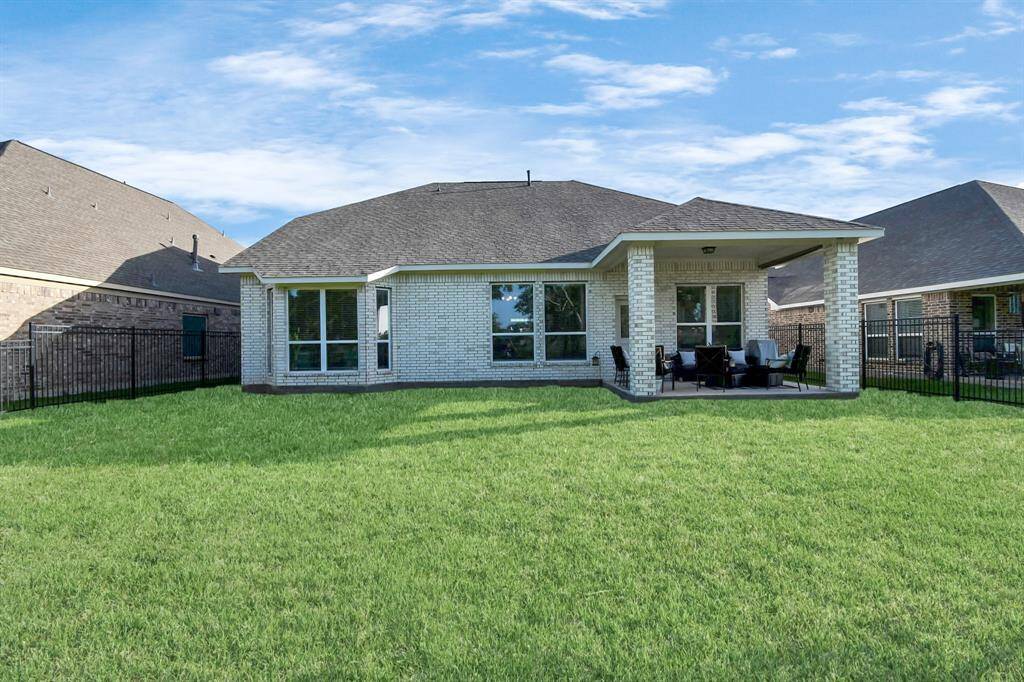 This home features brick on all for sides. It's covered back patio is perfect for lounging and drinking cups of coffee in the morning or a cold drink in the afternoon while enjoying the green space behind the home, because there are no back neighbors.
