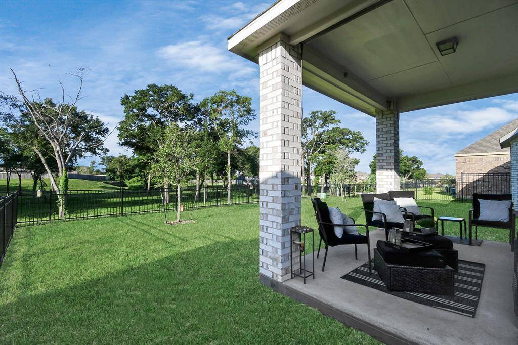 This home features brick on all for sides. It's covered back patio is perfect for lounging and drinking cups of coffee in the morning or a cold drink in the afternoon while enjoying the green space behind the home, because there are no back neighbors.