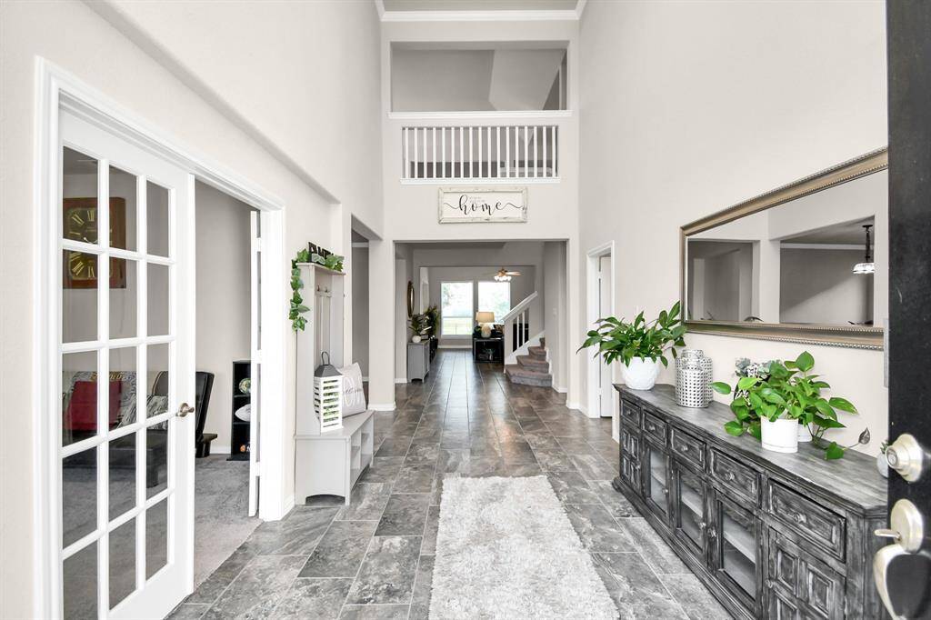 The moment you and your guests pass through the front door you will be impressed by the beautiful upgraded tile flooring that covers most of the living areas on the first floor. Immediately to your left you will see to french doors leading to the study/office.