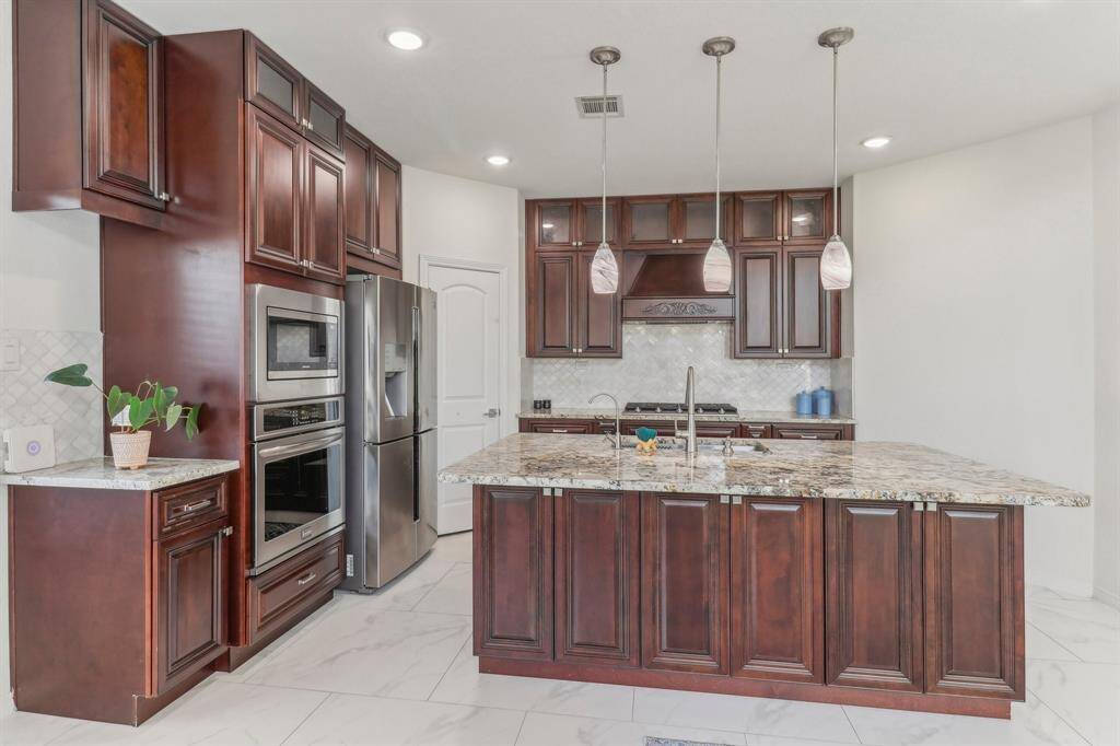 Spacious kitchen with modern lighting fixtures