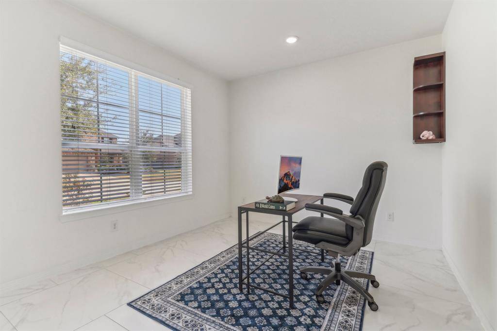 This photo shows a bright home office with glass French doors, creating a modern and inviting workspace.