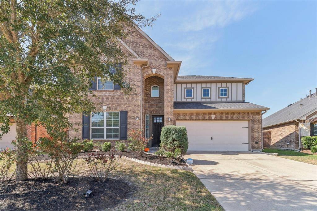 well-maintained landscaping, including bushes and rose plants,