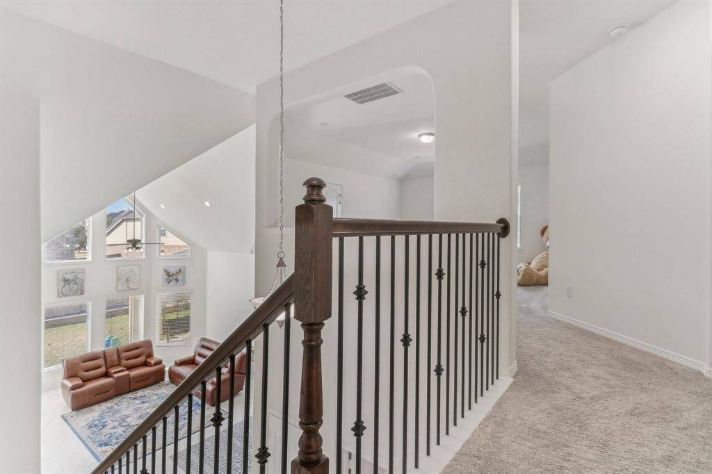 This photo shows a covered patio area with a ceiling fan.
