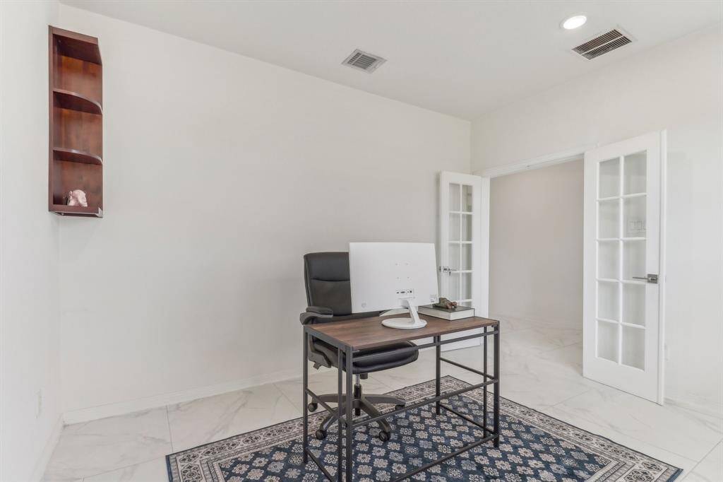 This photo showcases a spacious, open-concept living area with high ceilings and abundant natural light.