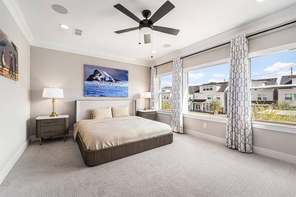 Spacious primary bedroom offering a serene retreat, complete with a built-in sound system and automated blinds for ultimate comfort and convenience.