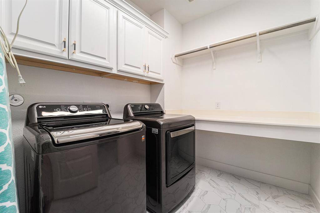 Spacious laundry room conveniently connected to the primary closet, offering ease and efficiency for everyday living.
