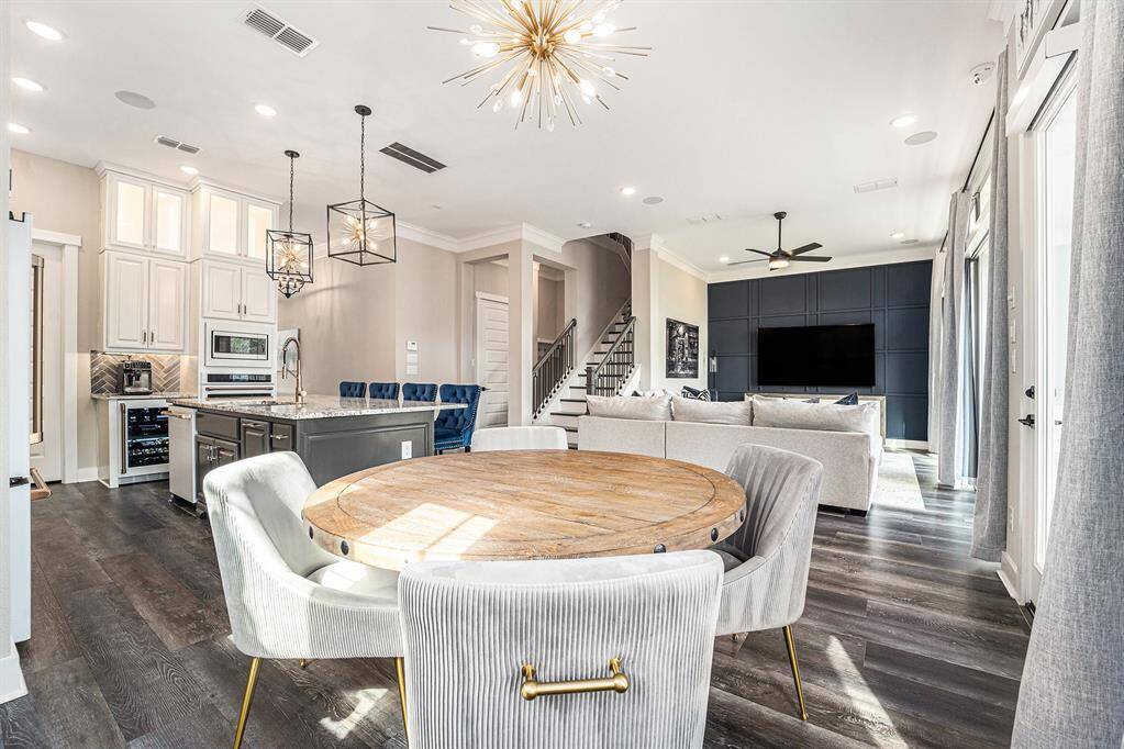 Bright and inviting open floor plan enhanced by upgraded lighting, creating a stylish and modern ambiance.