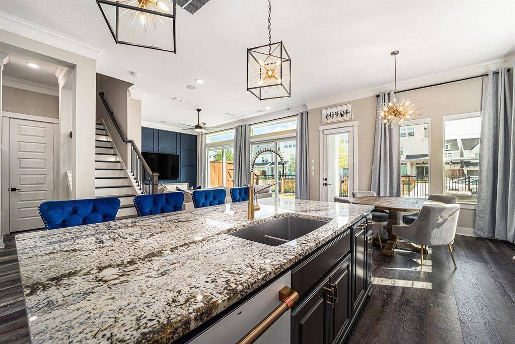 Expansive open floor plan seamlessly flows to the outdoors through two 8" sliding doors, featuring an automatic blind system that offers convenience and privacy with ease.
