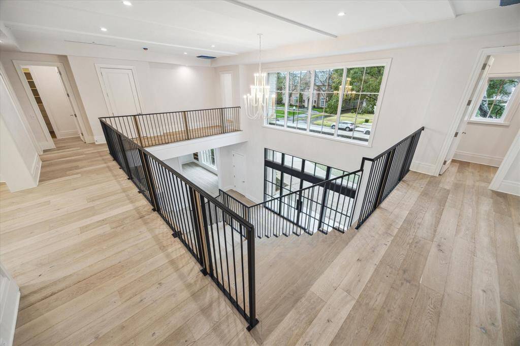 Second floor landing and stairwell. Five bedrooms on the second level, all with private baths. Cased opening to gameroom