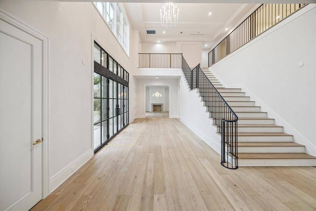 Formal entry with white oak wide plank flooring. Looking towards dining room.