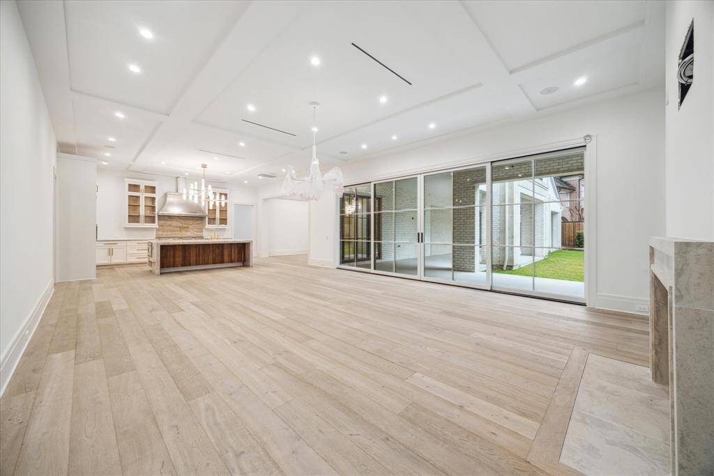 Great room looking towards kitchen and breakfast room.  Access and views to the covered porch and backyard