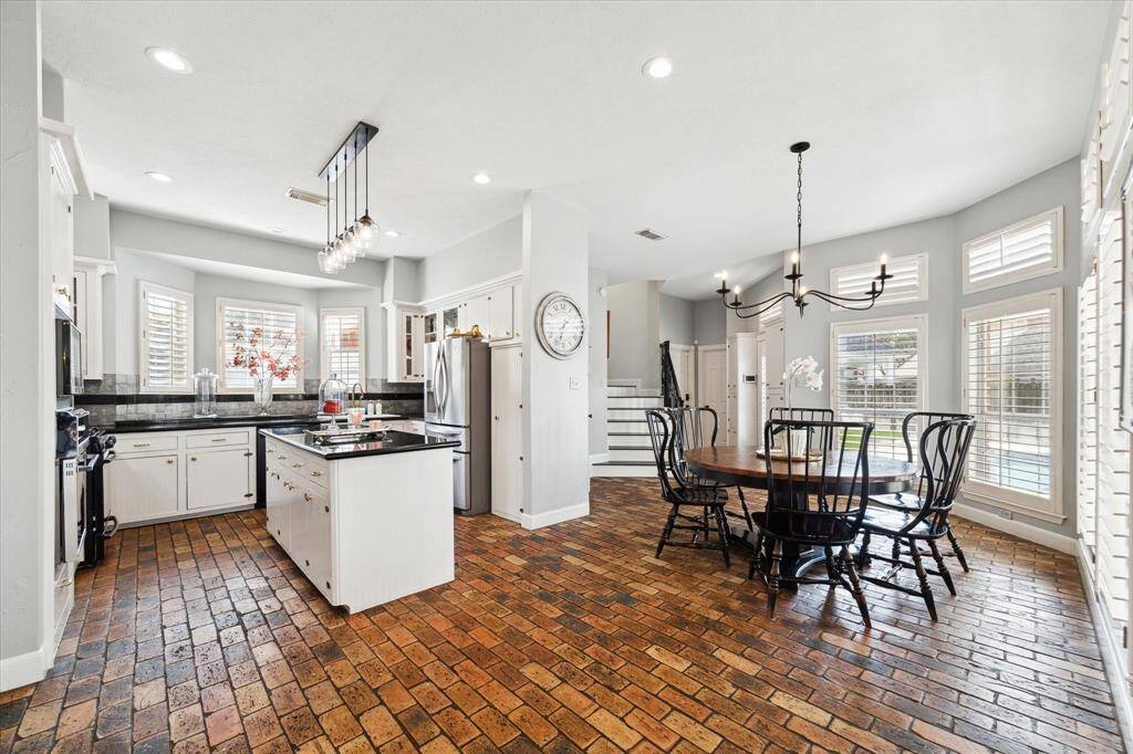 Warm and elegant large kitchen and breakfast area has brick flooring. Back staircase from the There is a back from the breakfast area.
