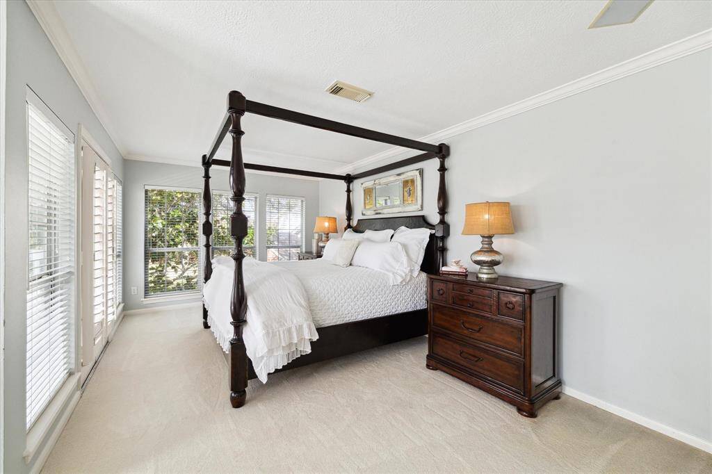 Beautiful white carpeting, plantation shutters with french doors leading to the balcony overlooking the expansive backyard.