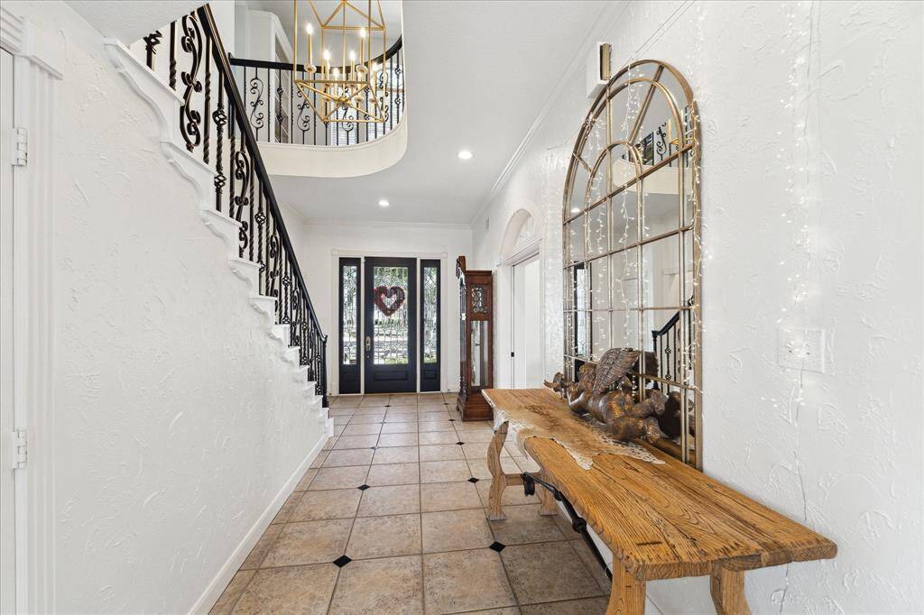 Two story entry. Wrought iron spindles. Beautiful light fixture.